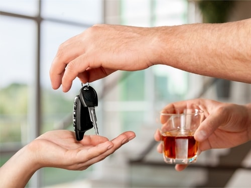 person drinking giving keys