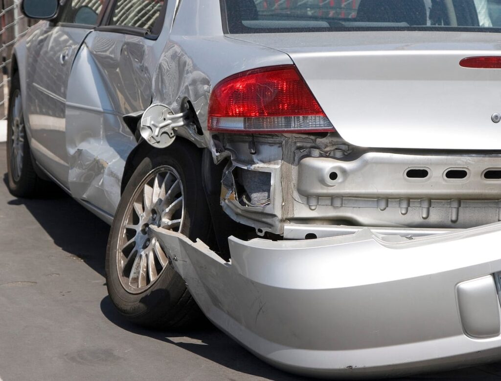 Damage to the read-end and tire of a vehicle after its been in a car accident.