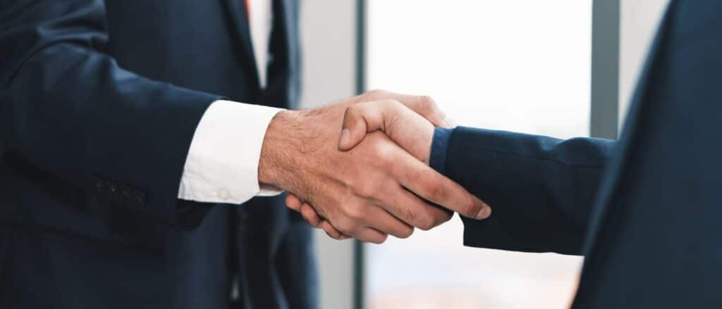 A car accident attorney in Tampa is shaking hands with their client.