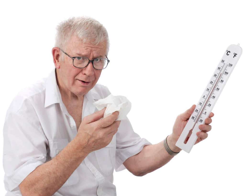 Senior citizen holding a thermometer