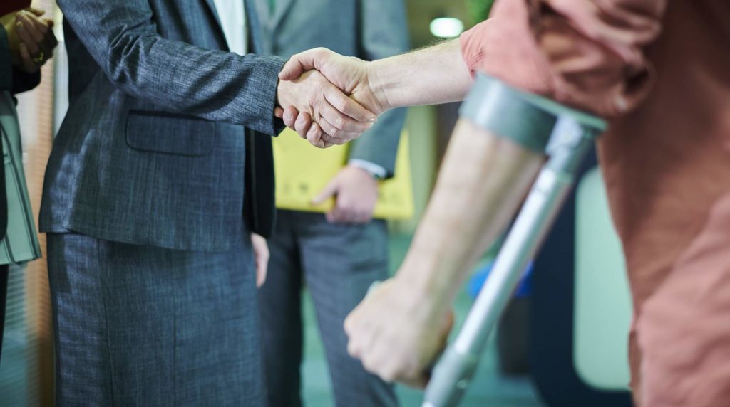 victim shaking hands with personal injury attorney