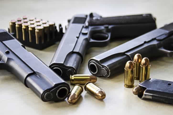 Handguns on table with ammunition