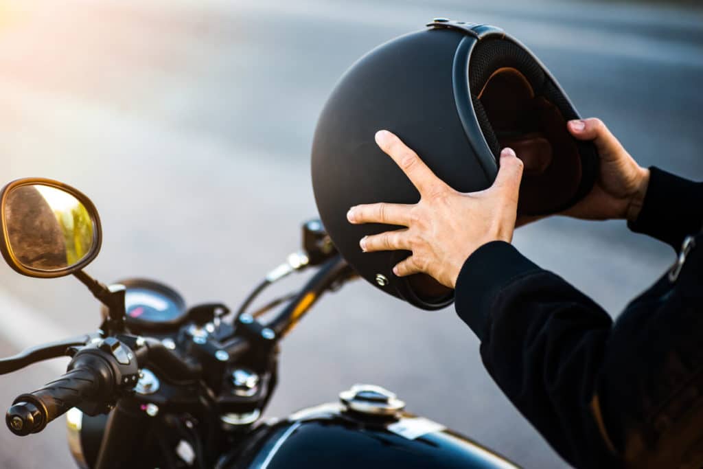 motorcycle rider getting ready to put helmet on
