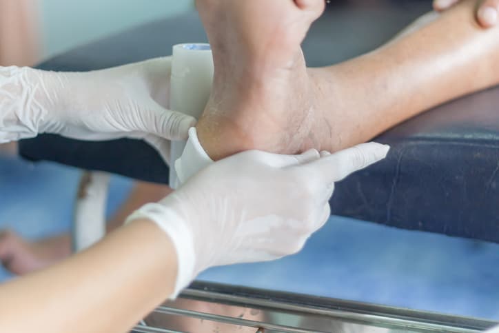 Applying gauze to injured foot