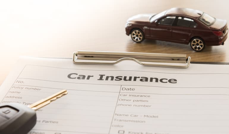Car insurance form with keys and toy car
