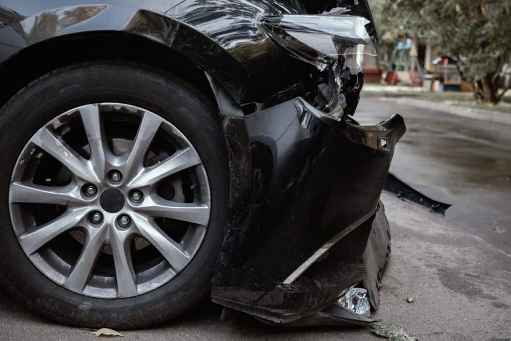 A damaged front end of a black vehicle in Tampa after an accident.