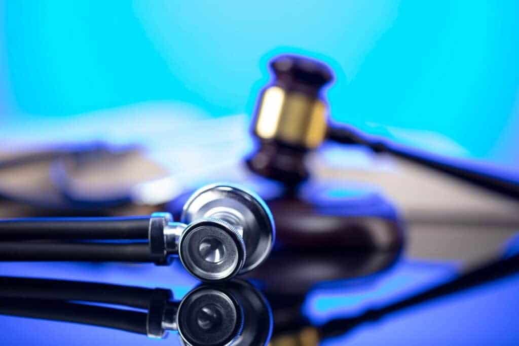 A gavel and a stethoscope on a desk