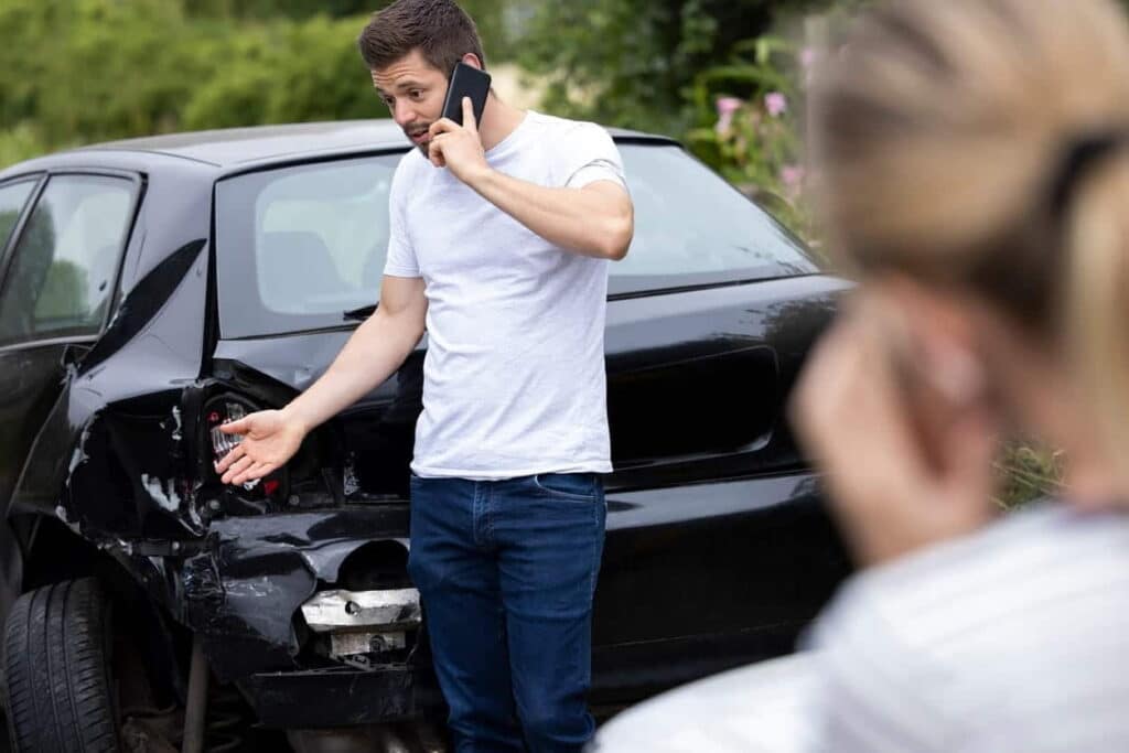 Man on phone after an uber car accident 