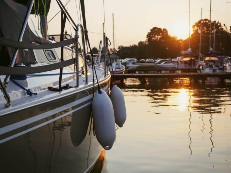 A Side View Of A Boat Docked In The Water.