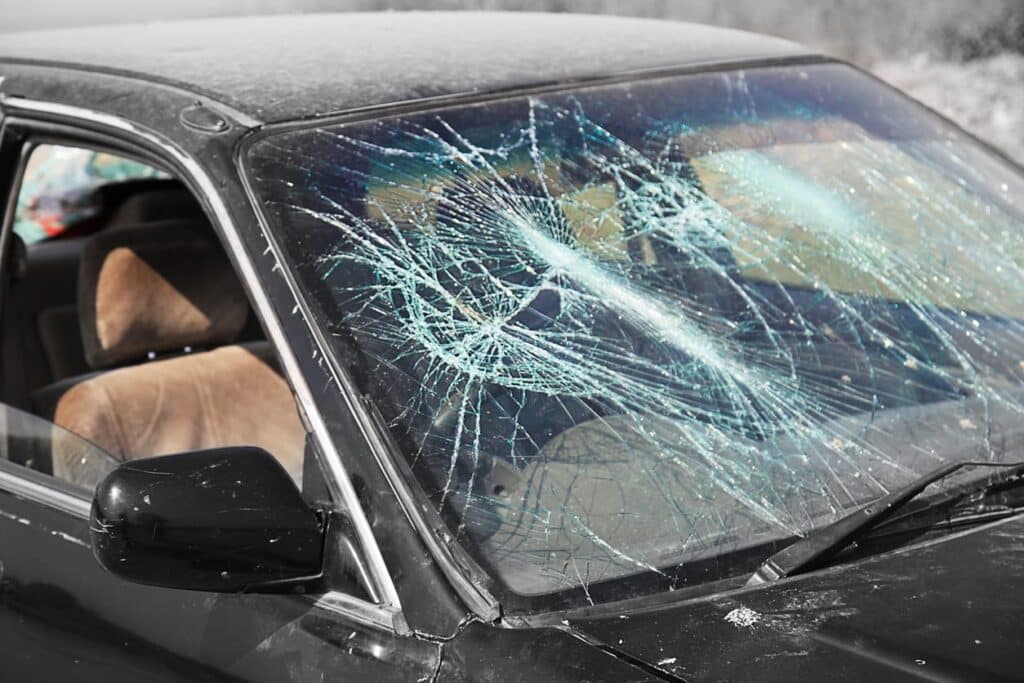 A smashed windshield from a car accident.