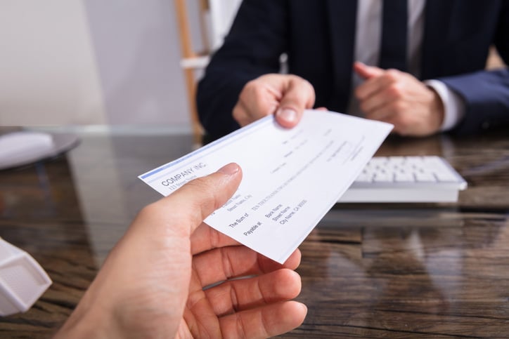 A person accepting a check from an accident attorney