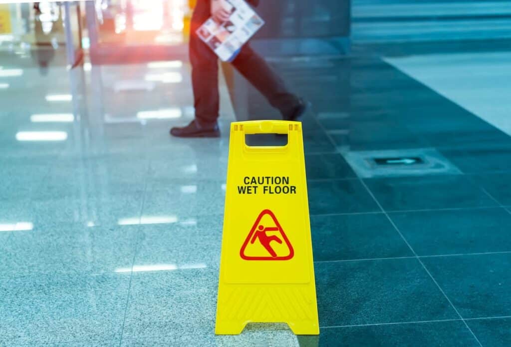 A yellow caution wet floor sign to help prevent a slip-and-fall accident.