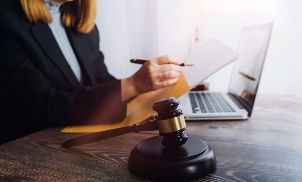 A Bicycle Accident Attorney At Their Desk With Papers A Laptop And A Gavel.