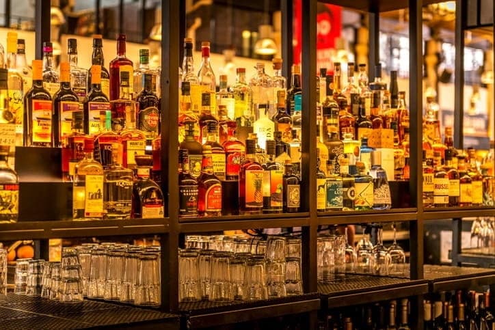 A display of liquor bottles behind a bar