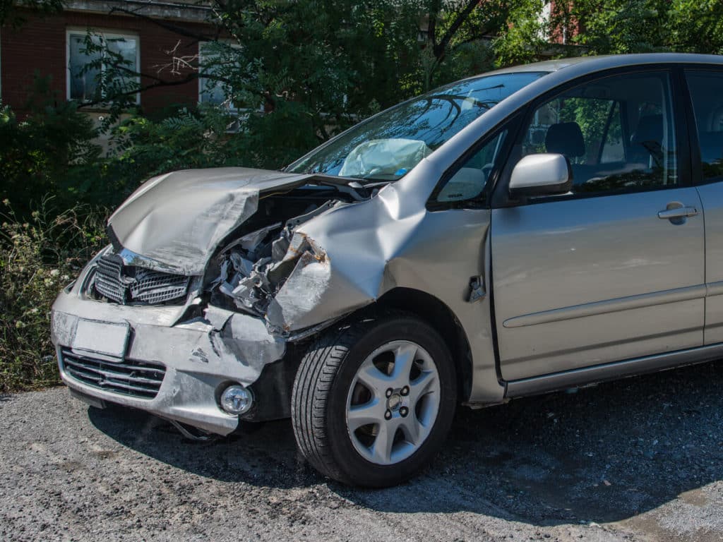 A car with front end damage after a rear end collision