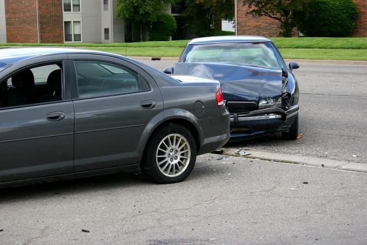 A car accident scene with two damaged vehicles