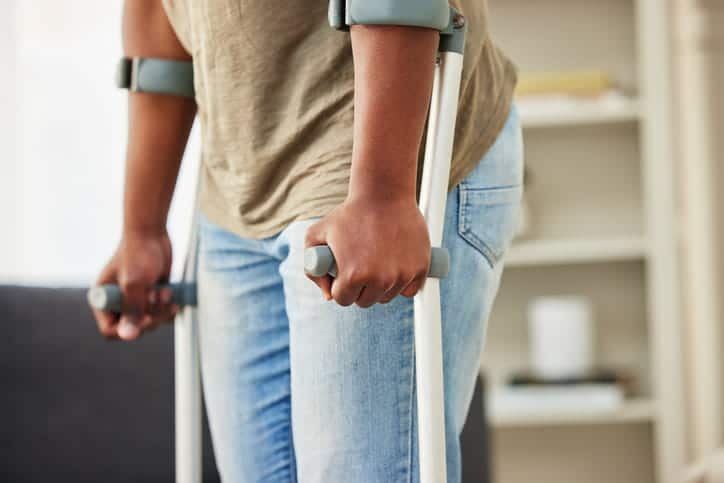 A man who suffered a personal injury using crutches