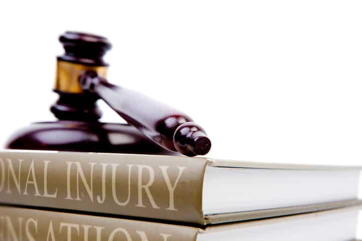 A gavel sitting on top of a book labeled personal injury.