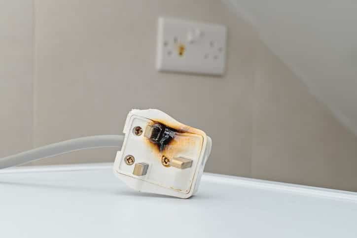 A faulty outlet that shows signs of having caught fire