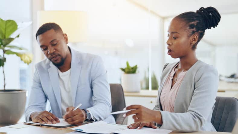 A Lawyer Discusses A Case With Their Client. 