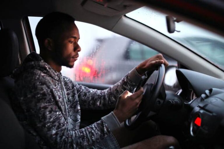A Man Texting On His Cellphone While Driving.