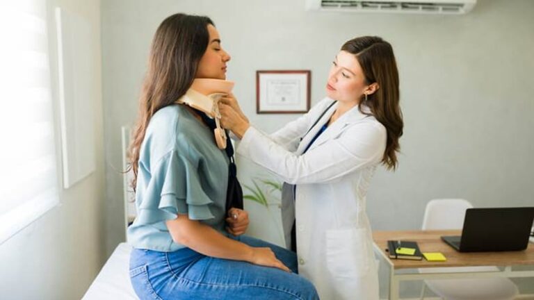 A Doctor Putting A Neckbrace On A Patient After She Suffered Whiplash In A Car Accident.