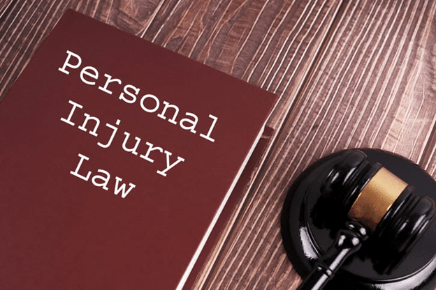 Clearwater Personal Injury Lawyer 1 A Red Book Titled &Quot;Personal Injury Law&Quot; Placed On A Wooden Surface Next To A Black Gavel With A Gold Band.